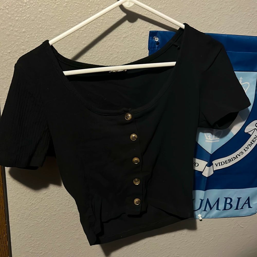 A size small tight shirt. Barely cropped and very stretchy. Never used